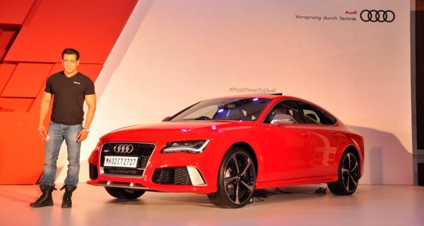 Mr. Salman Khan posing for the camera alongside the Audi RS 7