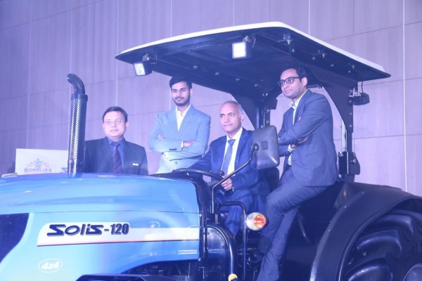 Mr. Deepak Mittal in middle sitting on 120 Hp tractor, Mr. Raman Mittal on extreme Left with Mr. Rahul Mittal on right of deepak Mittal with Gaurav Saxena on extreme right